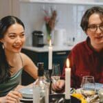 Grupa znajomych przy kolacji przy świecach w przytulnym mieszkaniu