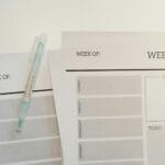 Tygodniowy planer posiłków na biurku z długopisem